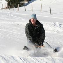en mand kører på et snowboard ned ad en snedækket skråning