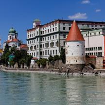 a building with a tower next to a body of water