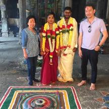 a group of people standing in front of a rug