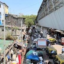 a busy street with cars and people in a city