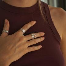 a woman wearing two rings on her hands