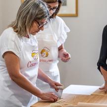 eine Gruppe von Frauen in einer Küche, die Teig macht