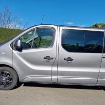 a silver van parked in a parking lot