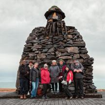 a group of people standing in front of a monument