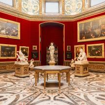 a room with statues and paintings on the walls