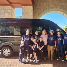 a group of people standing in front of a van