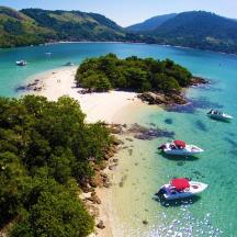 two boats on a beach in the water