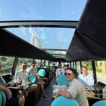 a group of people sitting at tables in a bus