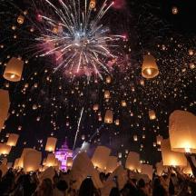 a crowd of people standing in front of a fireworks display