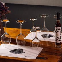 a group of wine glasses and a bottle on a table