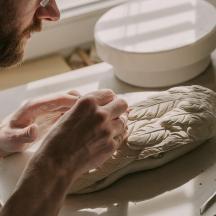 a man is kneading a cake on a table