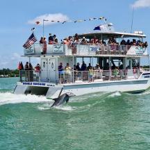 a boat full of people riding on the water