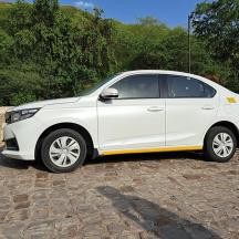 a white car parked on a brick road