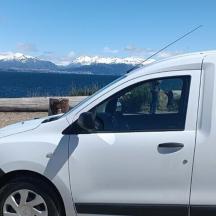 a white van parked next to a body of water
