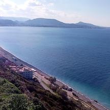 a view of a beach with buildings and the ocean