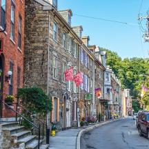 a street in a town with cars parked on the road