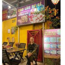 a woman standing in front of a restaurant