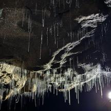 an image of icicles on the water at night