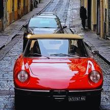 two cars parked next to each other on a street