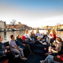 a group of people sitting on a boat in the water