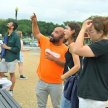 a group of people standing around in a park