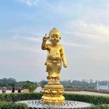 a large gold statue in a park