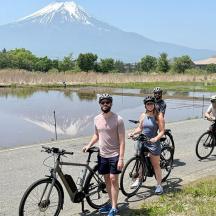 a group of people on bikes with a mountain in the background