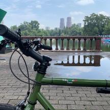 a green bike parked in front of a body of water