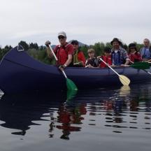 a group of people in a boat on the water