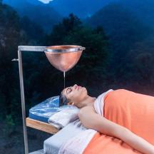 a person laying on a bed with a funnel on it