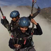 two people are zip lining in the mountains