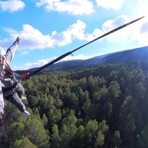 a person hanging from a rope in the air