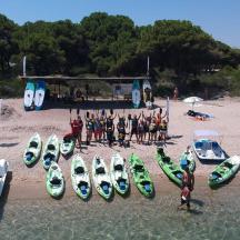 a group of people standing in the water next to surfboards