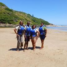 a group of people standing on the beach
