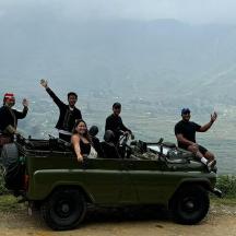 a group of people sitting in the back of a jeep