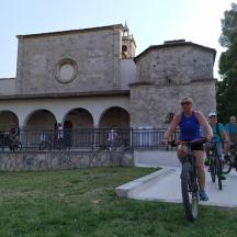 a group of people riding bikes in front of a building