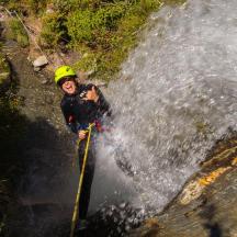 a man is standing in front of a waterfall