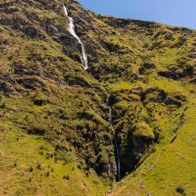 a waterfall on the side of a mountain