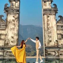 a man and a woman standing in front of an old building