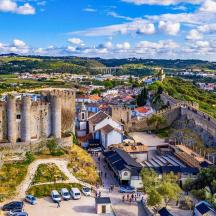 an aerial view of a city with a castle