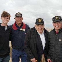a group of three men standing next to each other