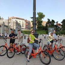 a group of people riding bikes down a street