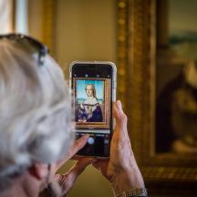 an older woman taking a picture with her cell phone