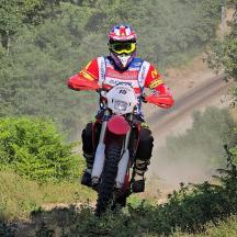 a person riding a dirt bike on a dirt road