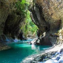 ein Fluss in einer felsigen Schlucht mit blauem Wasser