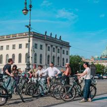a group of people on bikes in front of a building