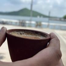 a person holding a cup of coffee in their hand