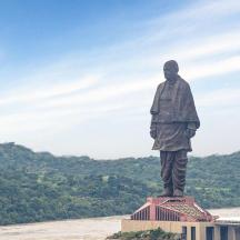 a statue of a man standing on top of a building