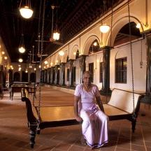 a woman sitting on a bench in a building