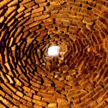 a brick tunnel with a light in the middle